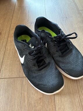 Nike women’s black running shoe. With white swoosh. Size 9.5 (euro 41)